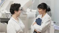 Doctor speaking to patient before a mammogram